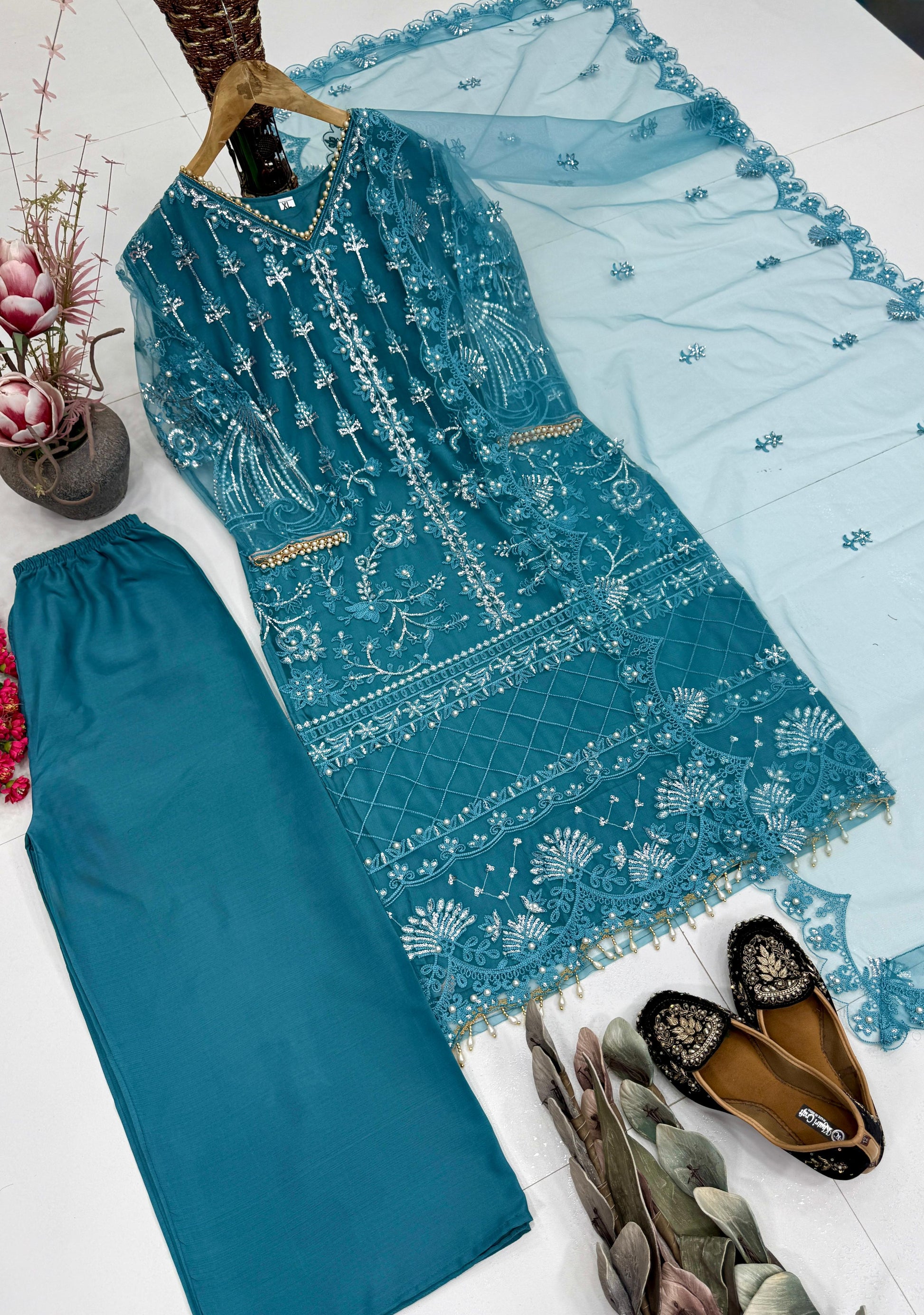 Lightweight teal green sheer net dupatta scarf displayed flat to showcase the detailed weave and finished borders.