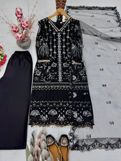 Flat layout of a black traditional tunic set paired with matching silk trousers and a long sheer embellished net scarf.