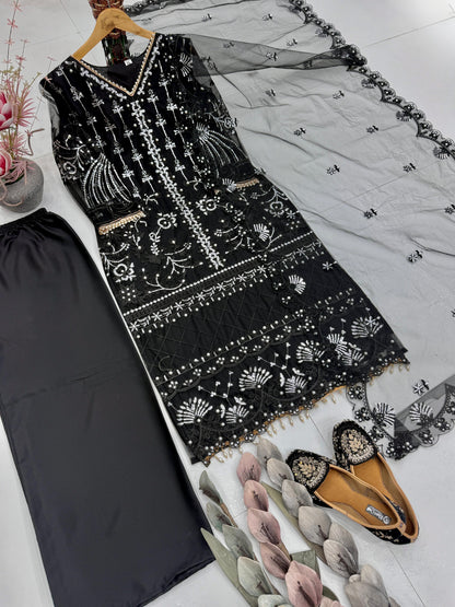 Back angle view of a black traditional ensemble showcasing the comfortable loose silhouette and smooth plain butter silk texture.