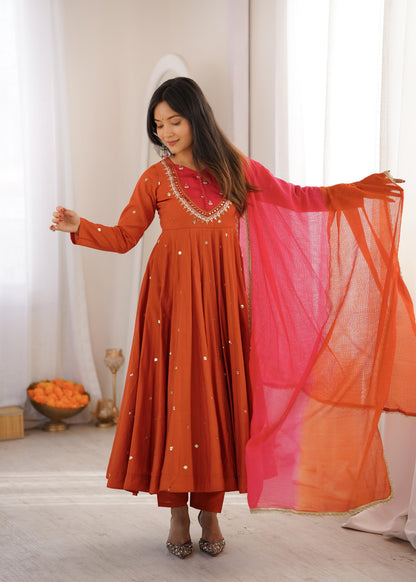 Focused shot of beautiful artisan sequence patterns and reflective real mirror textures on bright orange roman silk material near the chest.