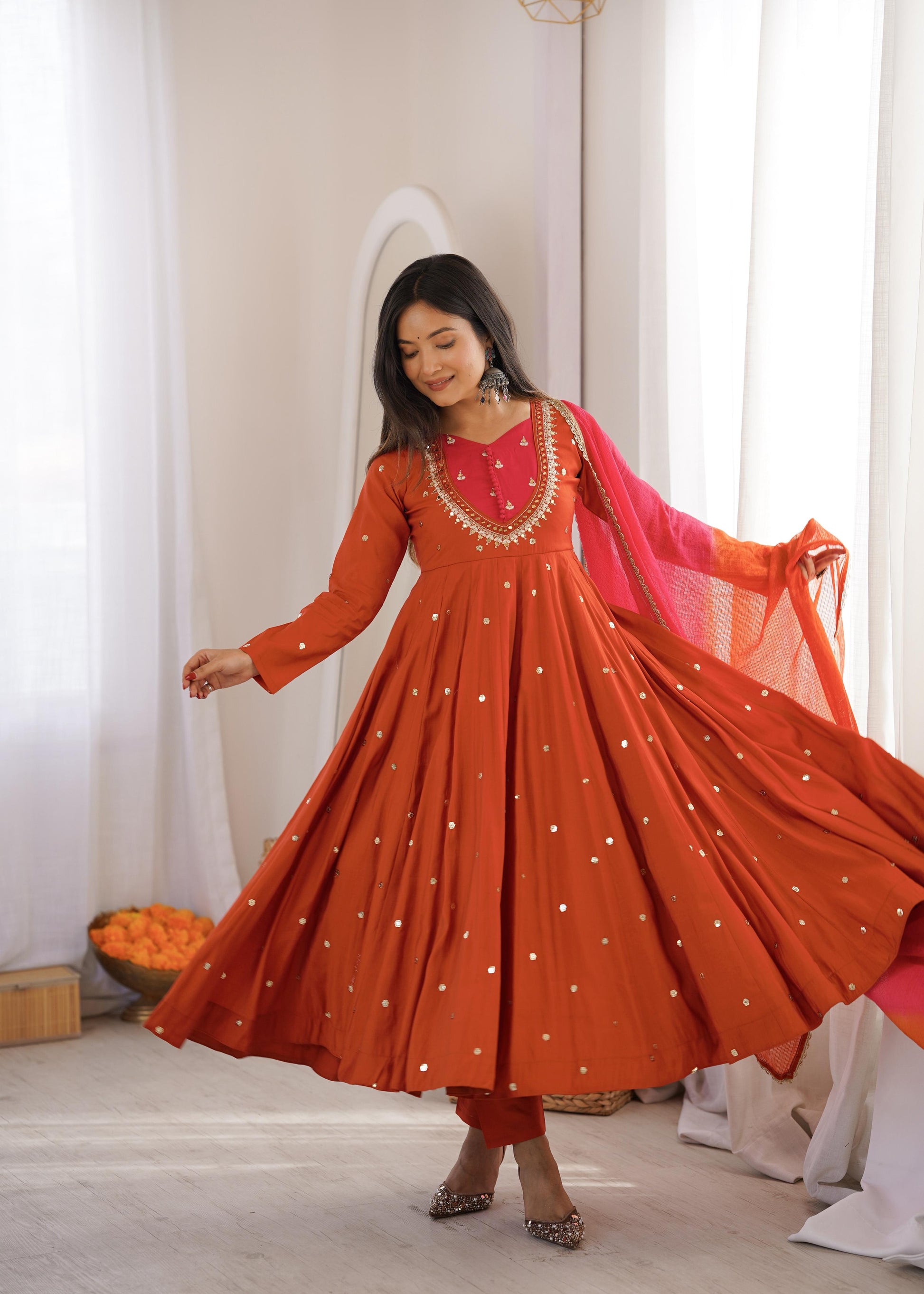 Swirling side profile view showing the generous three point seventy five meter flair and voluminous structural flow of an orange festive gown.