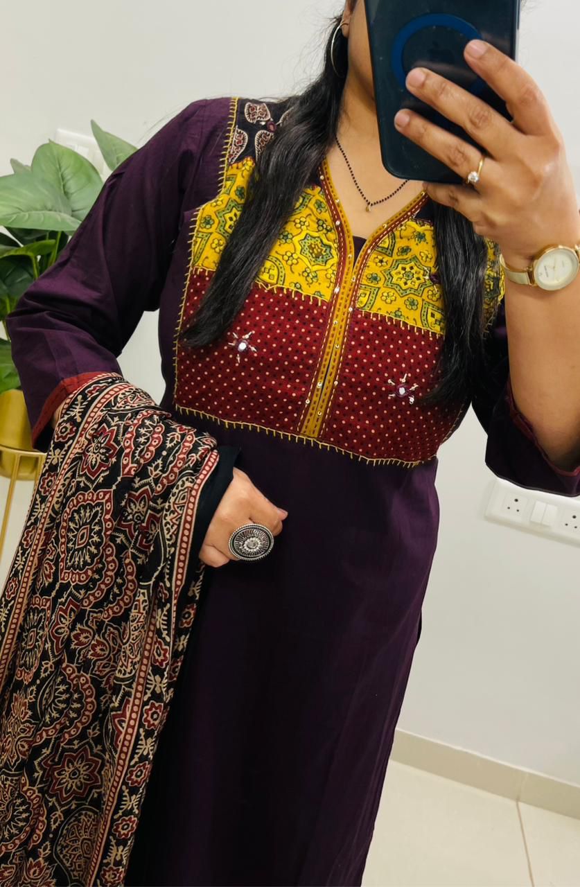 Close up view of traditional neckline hand work embroidery and crisp wine traditional patterns on a pure cotton kurta bodice.
