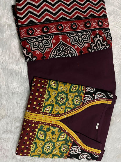 Side perspective presentation of the fully stitched wine color ethnic tunic highlighting the clean tailored borders and regular forty six plus inch length outline.