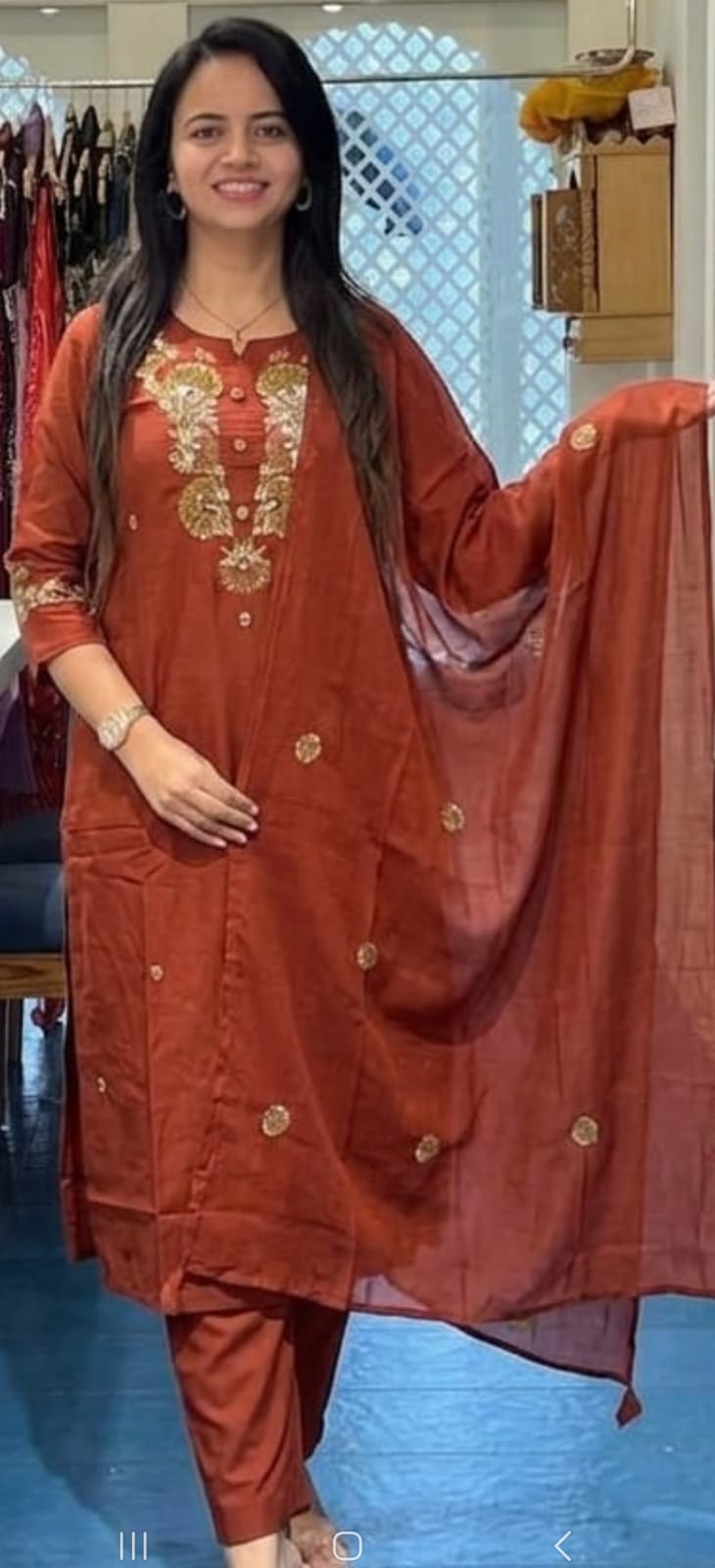 Front view of full three piece rust orange pure cotton super dying embroidery suit displaying a straight embroidered kurti pants and a malmal dupatta.