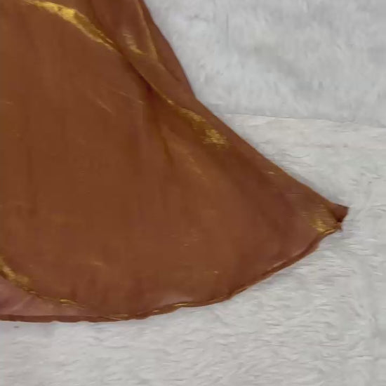 High definition product demonstration video showcasing the rich shimmer of handcrafted beads and the fluid movement of the flared brown sharara pants under studio lights.