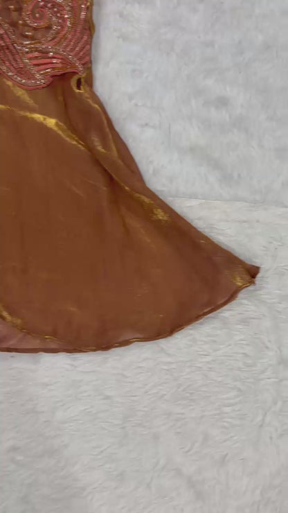 High definition product demonstration video showcasing the rich shimmer of handcrafted beads and the fluid movement of the flared brown sharara pants under studio lights.