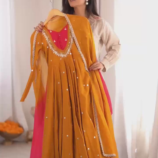 High definition retail display video highlighting the brilliant reflective sparkle of real mirror elements on the mustard yellow anarkali gown during a slow rotation.