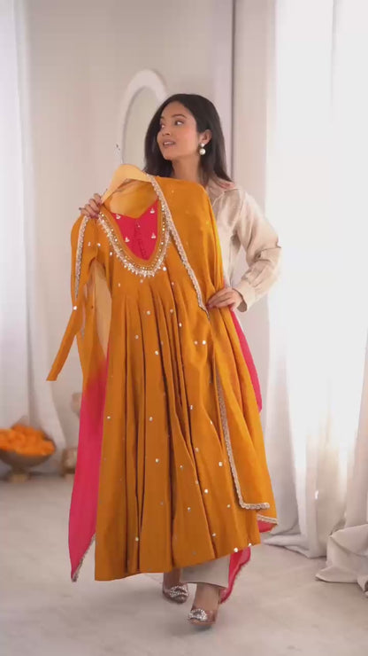 High definition retail display video highlighting the brilliant reflective sparkle of real mirror elements on the mustard yellow anarkali gown during a slow rotation.