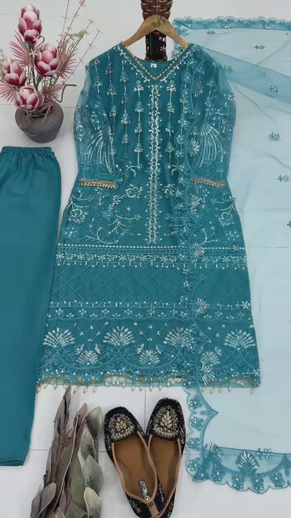 Showcase video displaying the natural fluid movement and detailed handcrafted chest pearl patterns of the teal blue soft net dress.