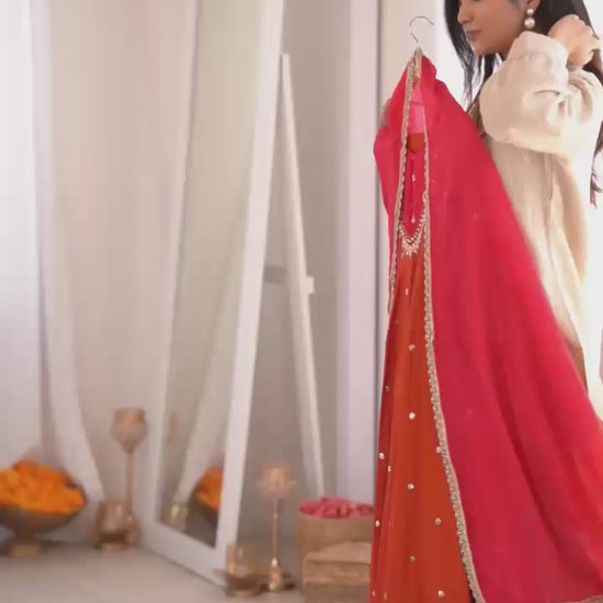 Studio product demonstration video highlighting the full coverage sleeve pattern and the effortless fluid movement of the orange silk skirt flair under warm studio lights.