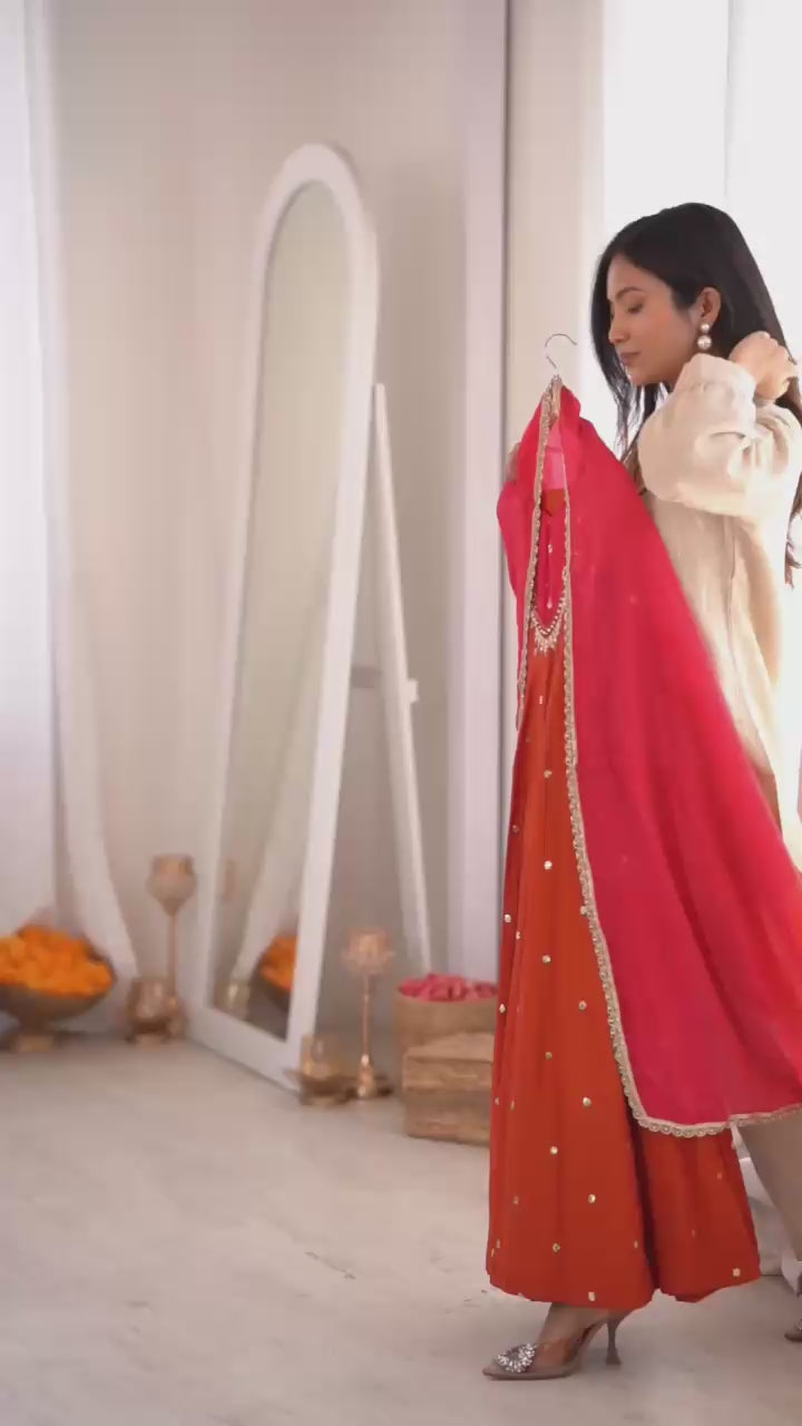 Studio product demonstration video highlighting the full coverage sleeve pattern and the effortless fluid movement of the orange silk skirt flair under warm studio lights.