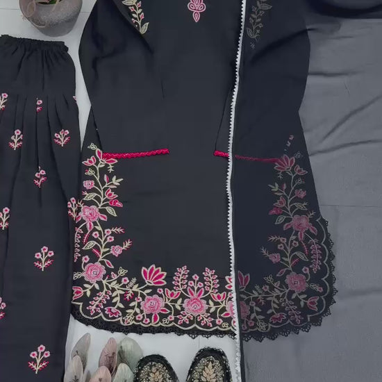 High definition retail display video highlighting the premium quality shine of the heavy embroidery work and the smooth movement of the black fabric under warm studio lights.