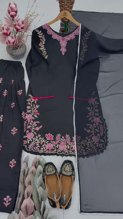 High definition retail display video highlighting the premium quality shine of the heavy embroidery work and the smooth movement of the black fabric under warm studio lights.