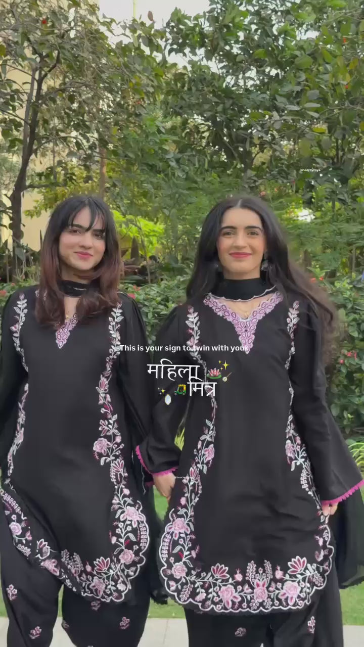 High definition retail display video highlighting the premium quality shine of the heavy embroidery work and the smooth movement of the black fabric under warm studio lights.