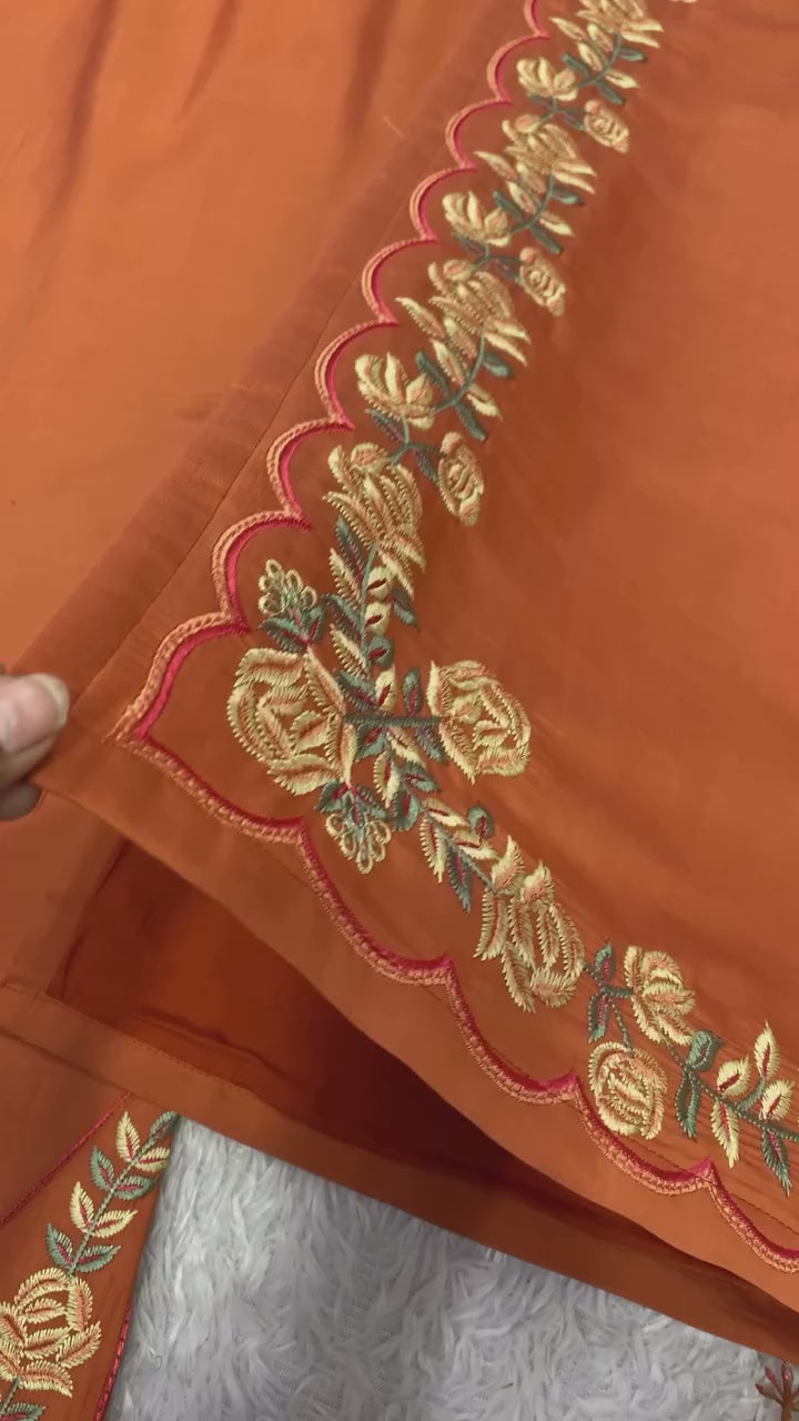 High definition retail display video highlighting the premium quality shine of embroidery work and the smooth movement of rust orange natural crepe silk material.