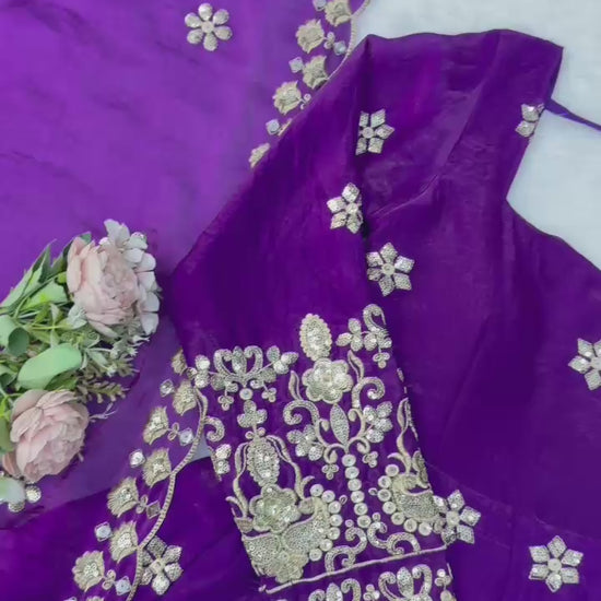 Studio product demonstration video highlighting the smooth texture of the fendy silk material and the premium shine of the purple ethnic dress under lights.