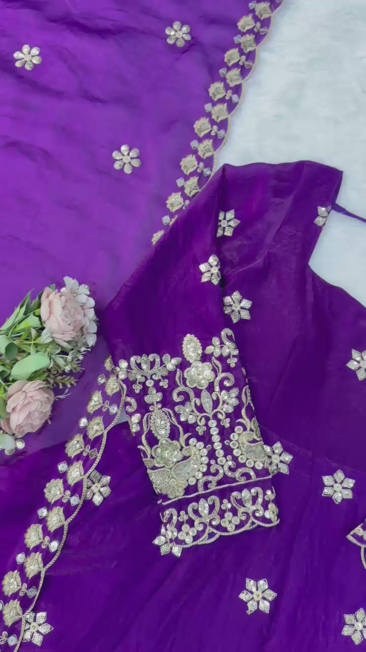 Studio product demonstration video highlighting the smooth texture of the fendy silk material and the premium shine of the purple ethnic dress under lights.