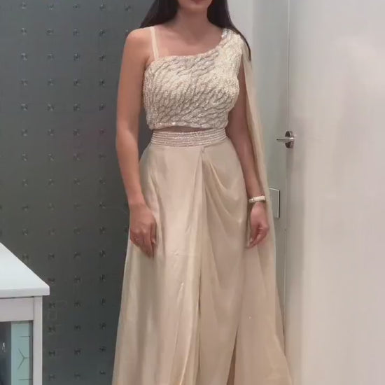 Product demonstration video highlighting the ease of movement and shimmering sequence embroidery details of the cream fusion outfit.