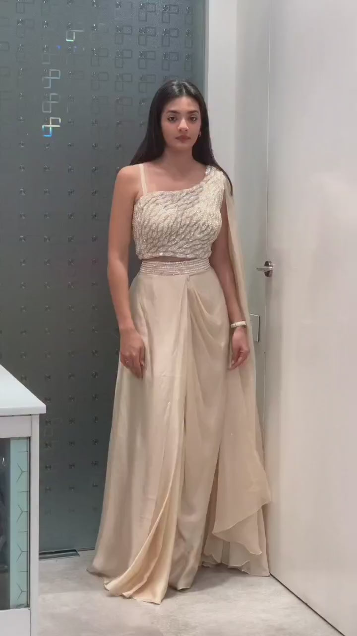 Product demonstration video highlighting the ease of movement and shimmering sequence embroidery details of the cream fusion outfit.