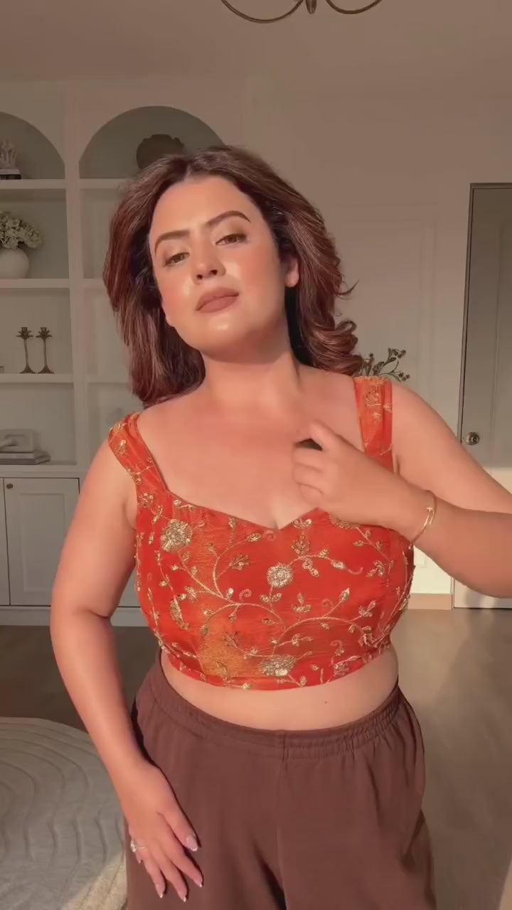 High definition retail display video highlighting the brilliant sparkle of sequence embroidery and the effortless fluid movement of the orange draped saree.