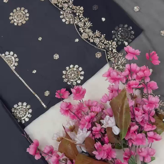 Close up video rotation highlighting the sparkling texture of metallic thread embroidery under warm festive lighting.
