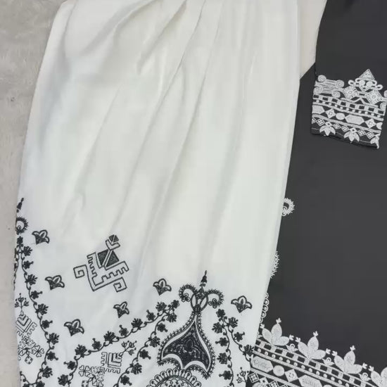 High definition retail display video highlighting the premium quality shine of embroidery work and the smooth movement of black natural crepe silk material.