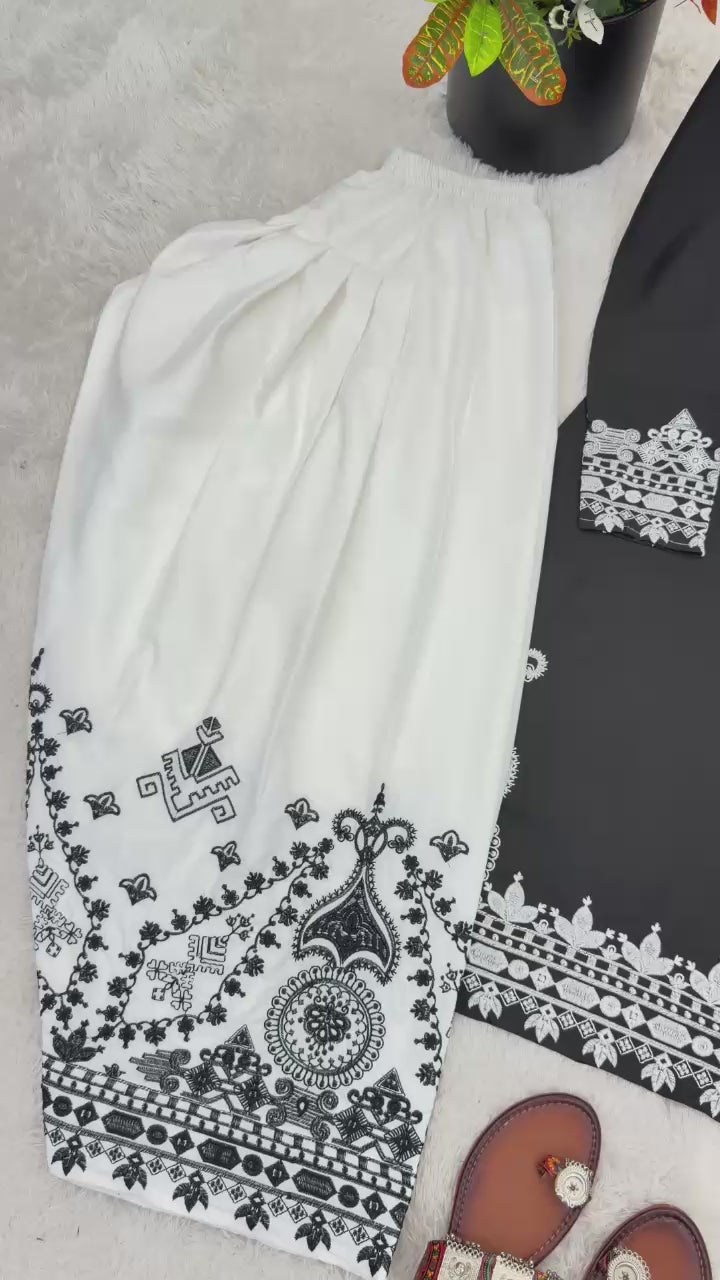 High definition retail display video highlighting the premium quality shine of embroidery work and the smooth movement of black natural crepe silk material.