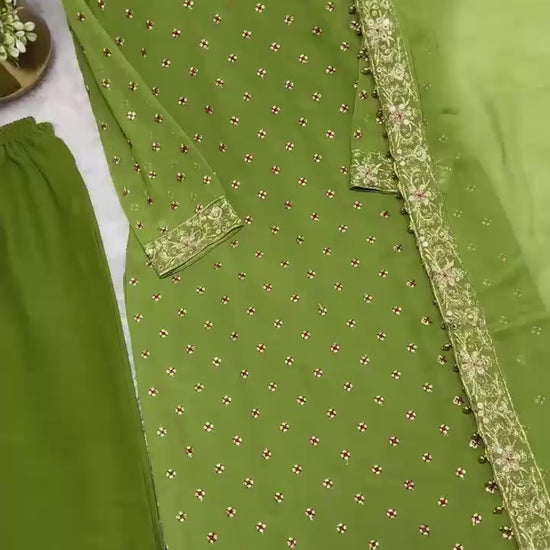 High definition retail display video highlighting the brilliant sparkle of both side sequence embroidery and the effortless movement of the green traditional dress under lights.