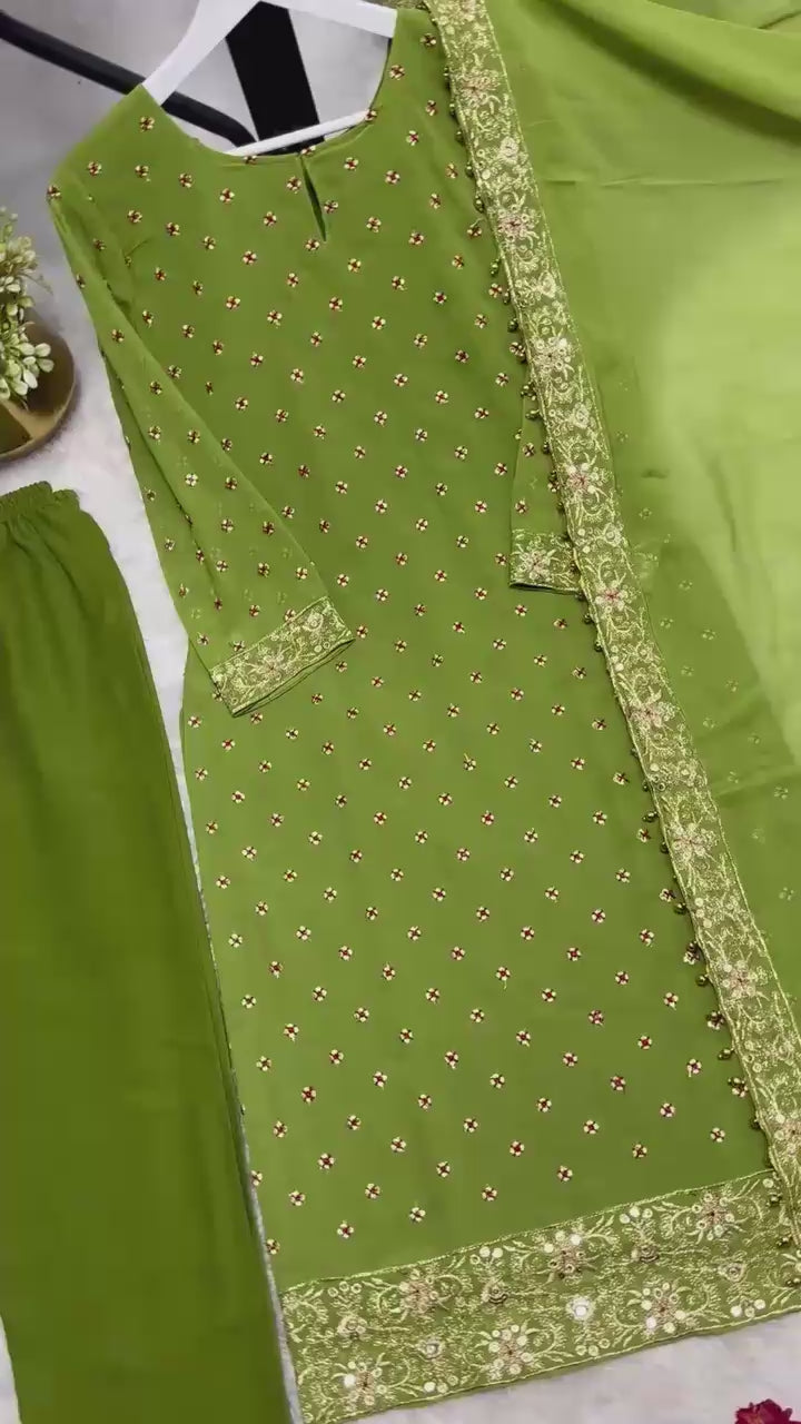 High definition retail display video highlighting the brilliant sparkle of both side sequence embroidery and the effortless movement of the green traditional dress under lights.